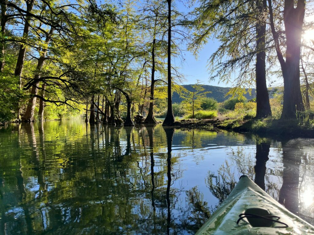 Calm water seen from a canoe in the Texas Hill Country
